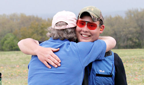 Men's American Trap winner Matt Perkins gets a hug from his coach.