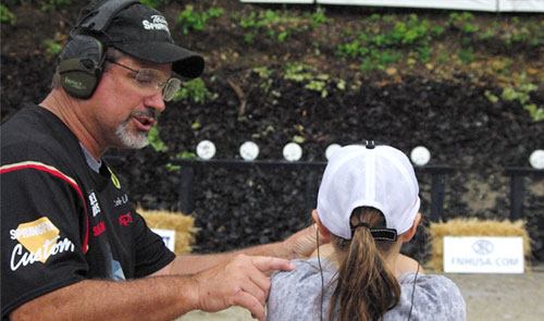 Rob Leatham teaching a young shooter at the Bianchi Cup Pro-Shooter Clinic