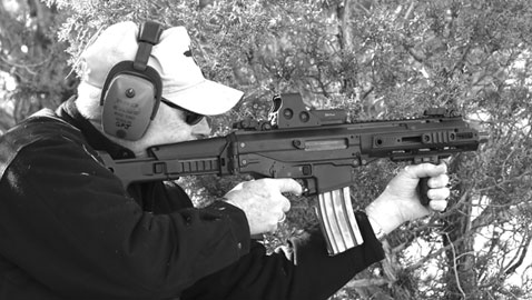 Johnston kneels to engage a far off steel target on Gunsite's Trail Walk.  The ACR-PDW performed superbly.