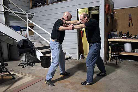 When the defender realizes that a punch is being thrown, he immediately responds with a “shoulder stop”—a powerful simultaneous thrust with both hands. The right palm hits the attacker on or near his shoulder, while the left hand hits somewhere on the arm near the elbow. This response is very instinctive and easily learned, yet will stop even the most powerful punch with ease.