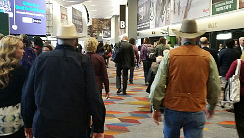 Michael Bane and Marshal Halloway (the guys with hats) moving fast from one appointment to another at the  2015 SHOT Show.